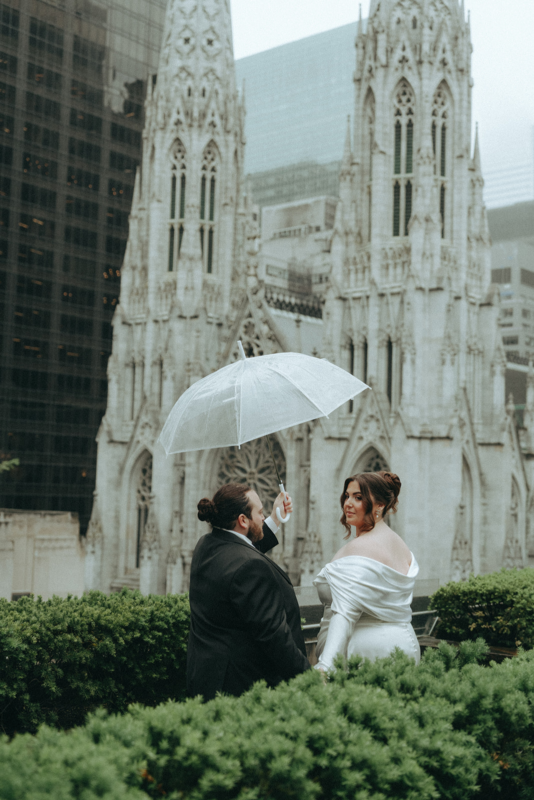 Madison + Dylan 620 Loft and Garden Wedding bride and groom posing on rooftop with umbrella at 620 loft & garden wedding, shot by elsie goodman, a destination and NYC wedding photographer