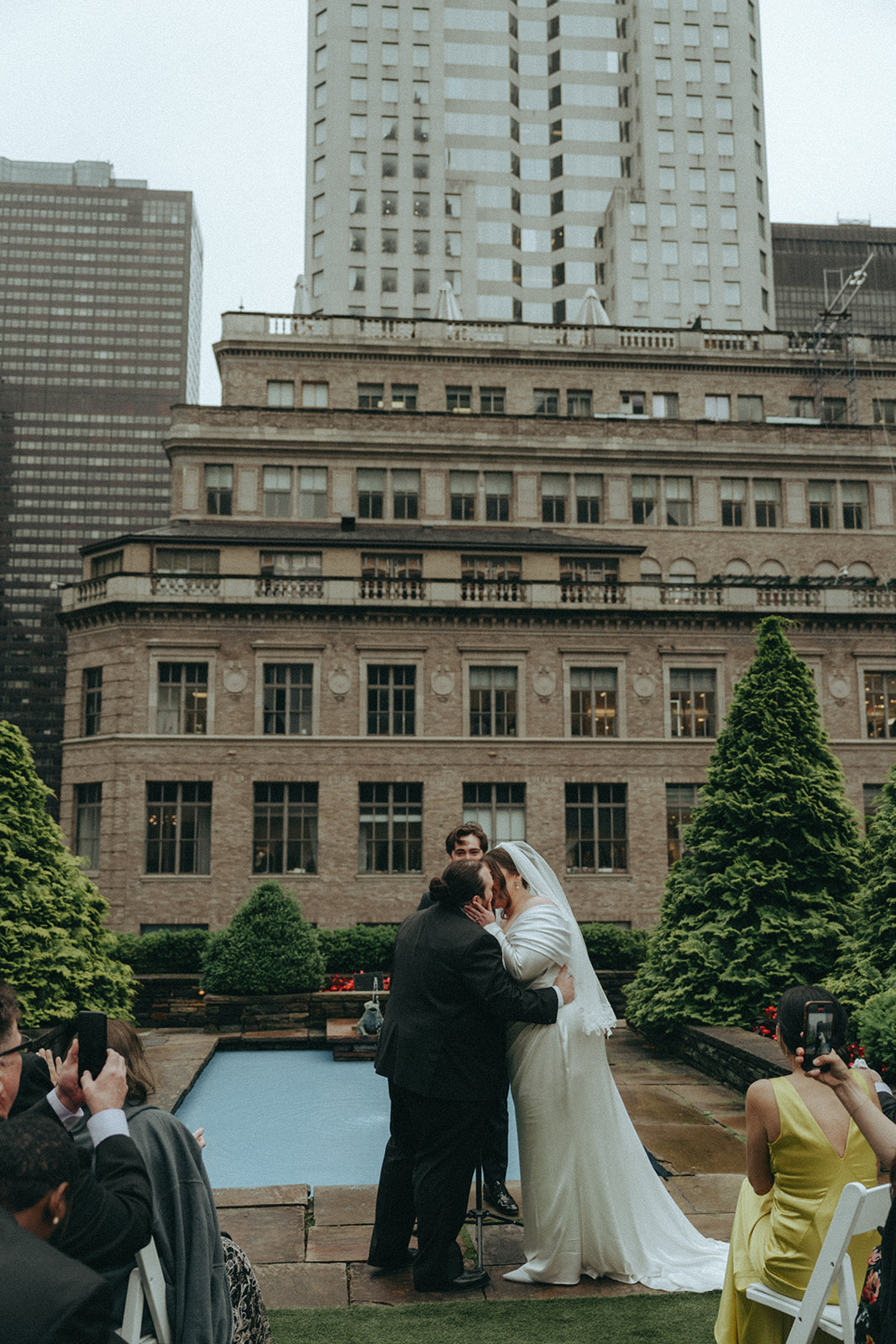 Madison + Dylan 620 Loft and Garden Wedding bride and grooms first kiss at 620 loft & garden wedding, shot by elsie goodman, a destination and NYC wedding photographer