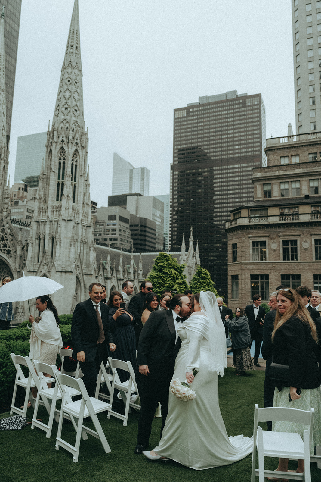Madison + Dylan 620 Loft and Garden Wedding bride and groom kiss while exiting ceremony at 620 loft & garden wedding, shot by elsie goodman, a destination and NYC wedding photographer