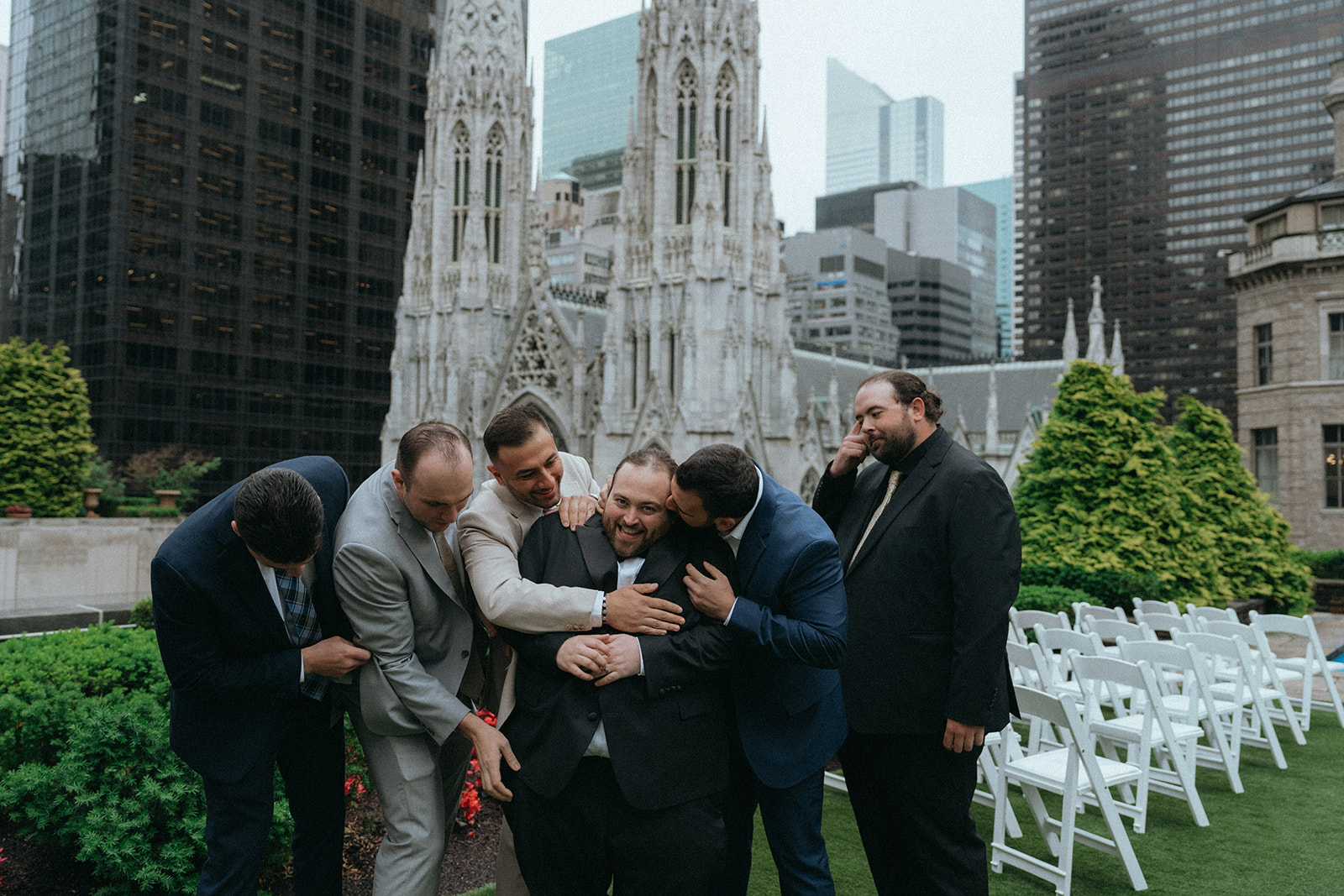 Madison + Dylan 620 Loft and Garden Wedding groom being hugged by friends at 620 loft & garden wedding, shot by elsie goodman, a destination and NYC wedding photographer
