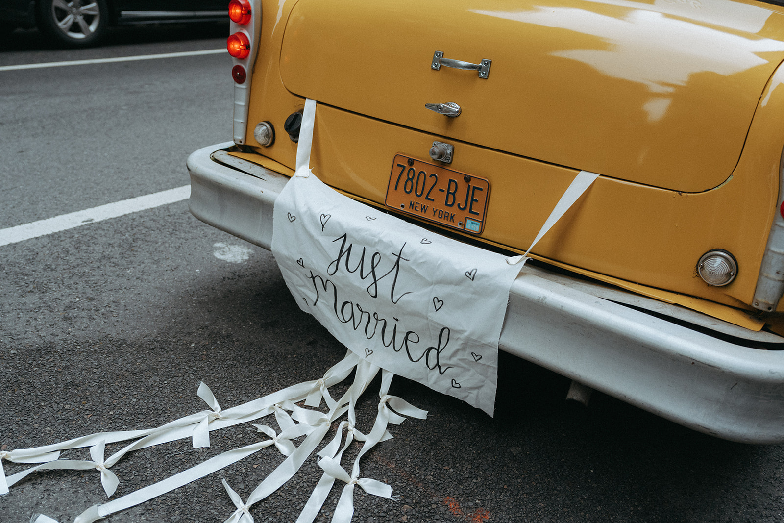 Madison + Dylan 620 Loft and Garden Wedding vintage cab with just married sign hanging from trunk, shot by elsie goodman, a destination and NYC wedding photographer