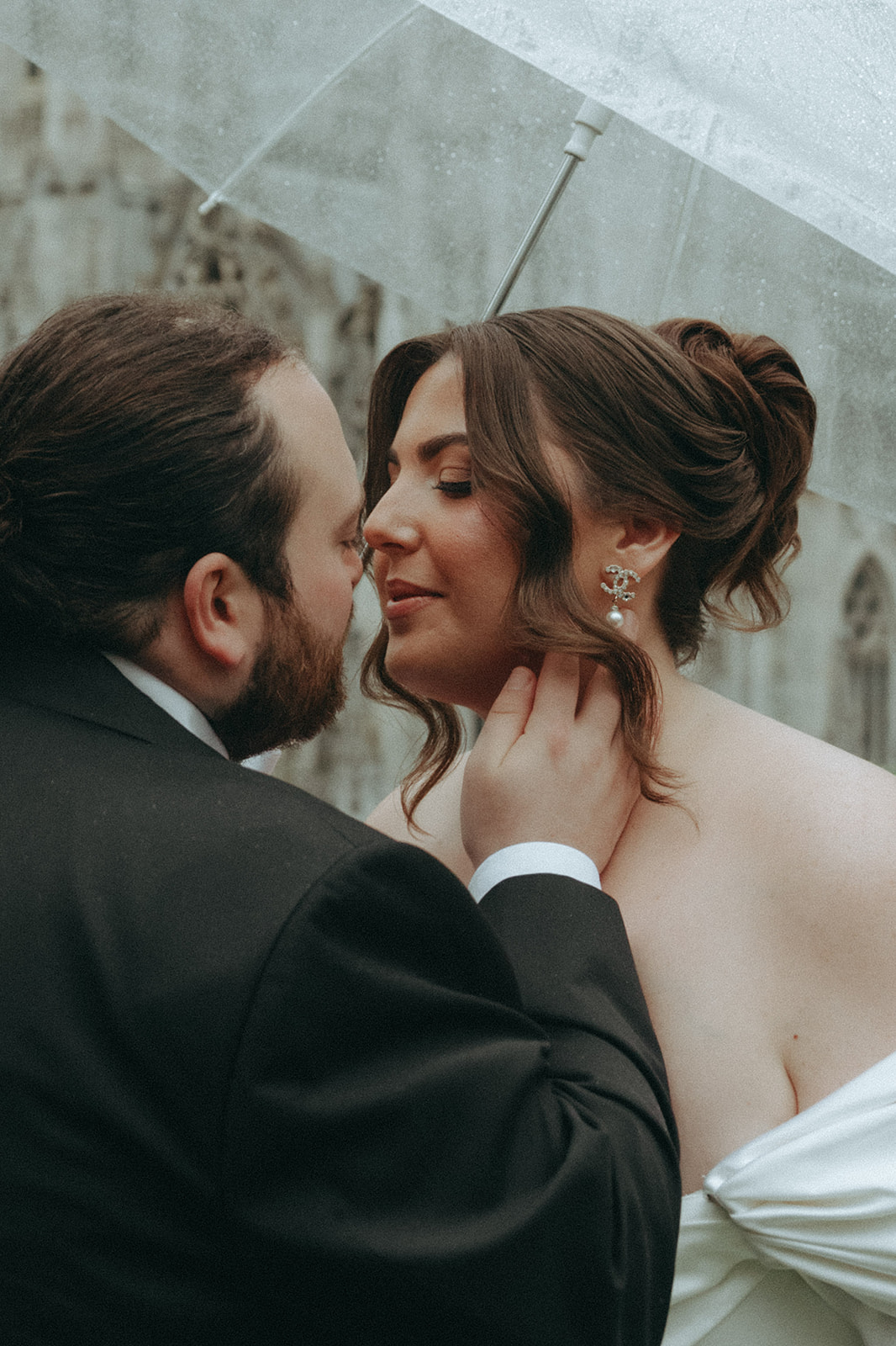 Madison + Dylan 620 Loft and Garden Wedding groom touching brides neck under umbrella on rooftop at 620 loft & garden wedding, shot by elsie goodman, a destination and NYC wedding photographer