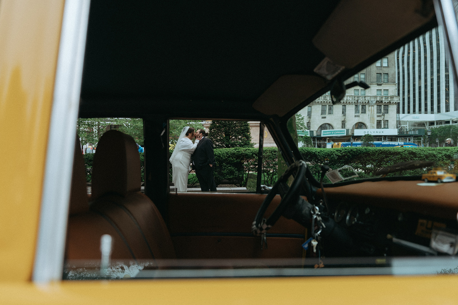 Madison + Dylan 620 Loft and Garden Wedding bride and groom shot through window of vintage taxi after 620 loft & garden wedding, shot by elsie goodman, a destination and NYC wedding photographer