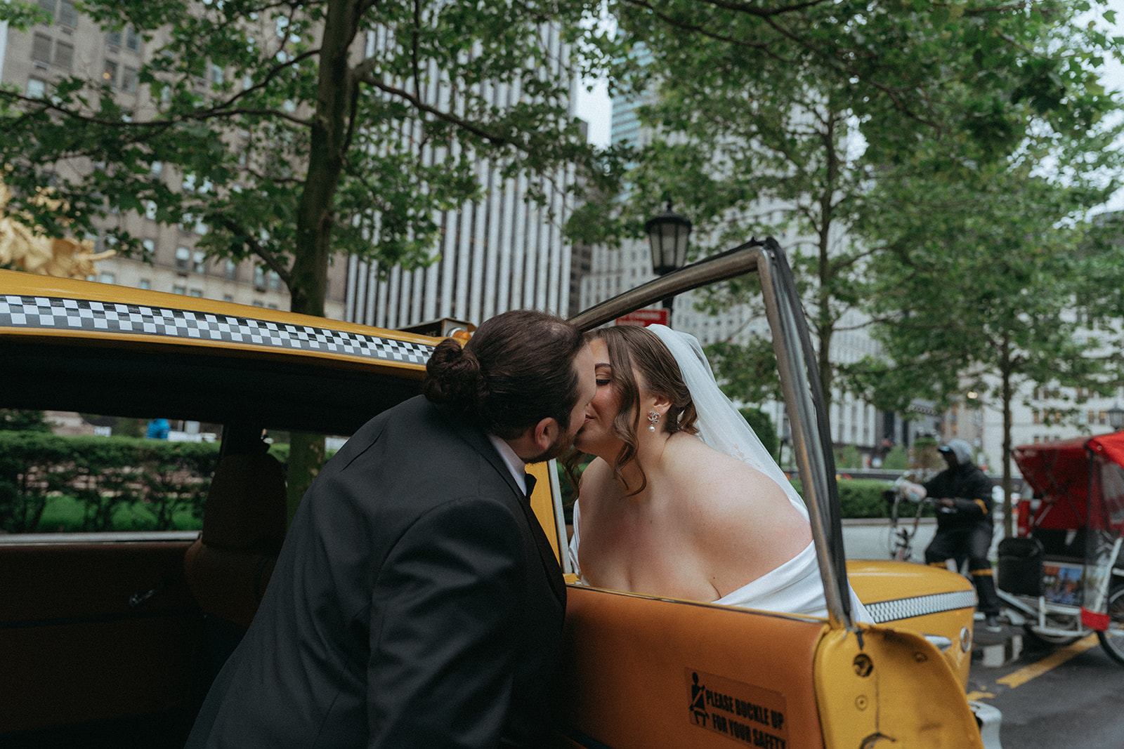 Madison + Dylan 620 Loft and Garden Wedding bride and groom kissing through window of a vintage taxi after 620 loft & garden wedding, shot by elsie goodman, a destination and NYC wedding photographer