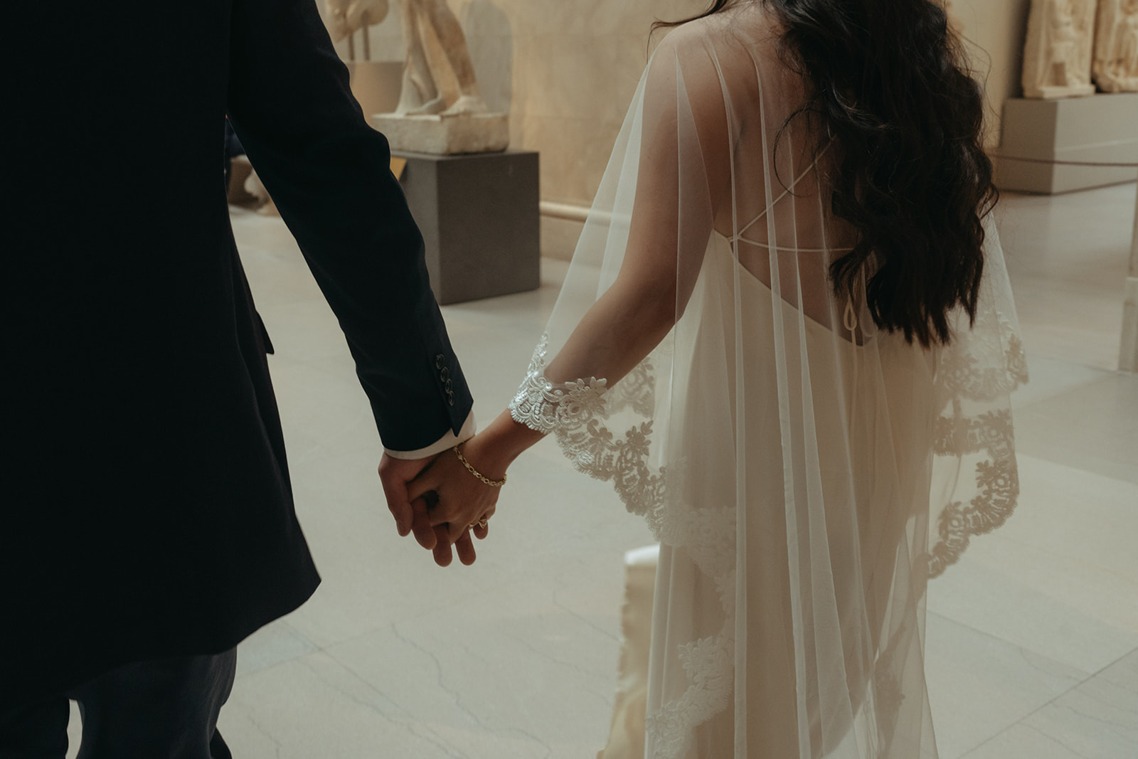 Alex + Bardo NYC Elopement Photos bride and groom walking and holding hands at the Met shot by elsie goodman, a destination, wedding and NYC elopement photographer
