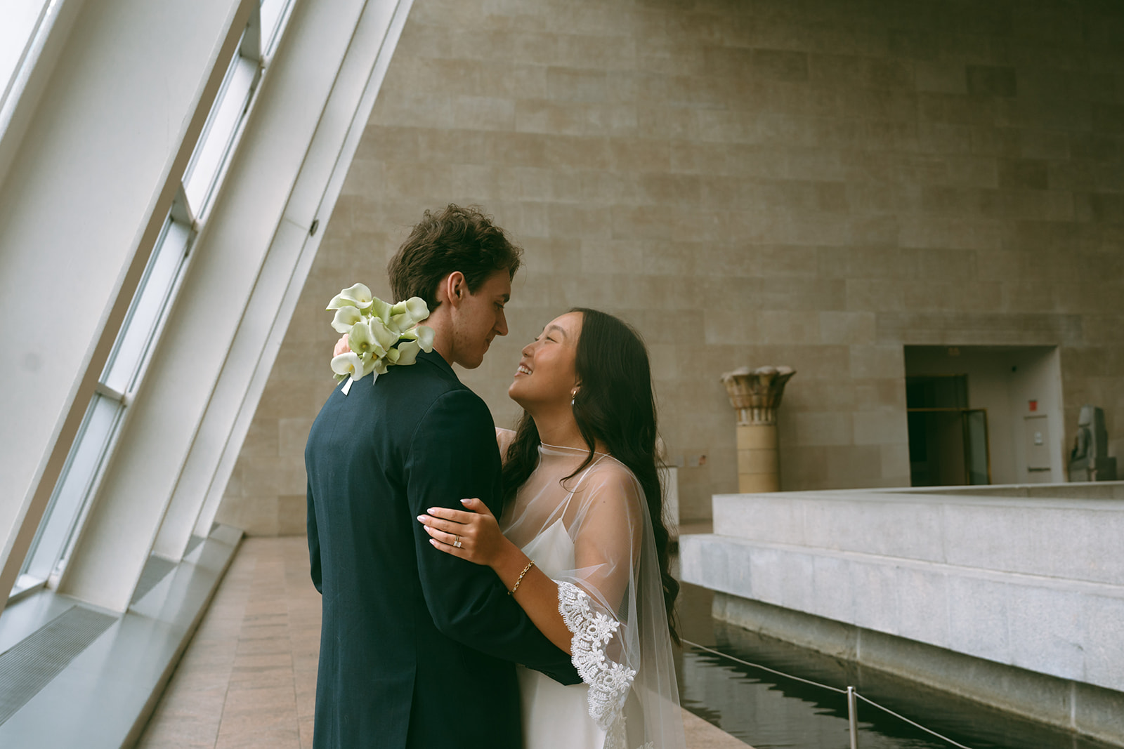 Alex + Bardo NYC Elopement Photos bride and groom looking at each other next to windows at the Met for elopement photos, shot by elsie goodman, a destination, wedding and NYC elopement photographer