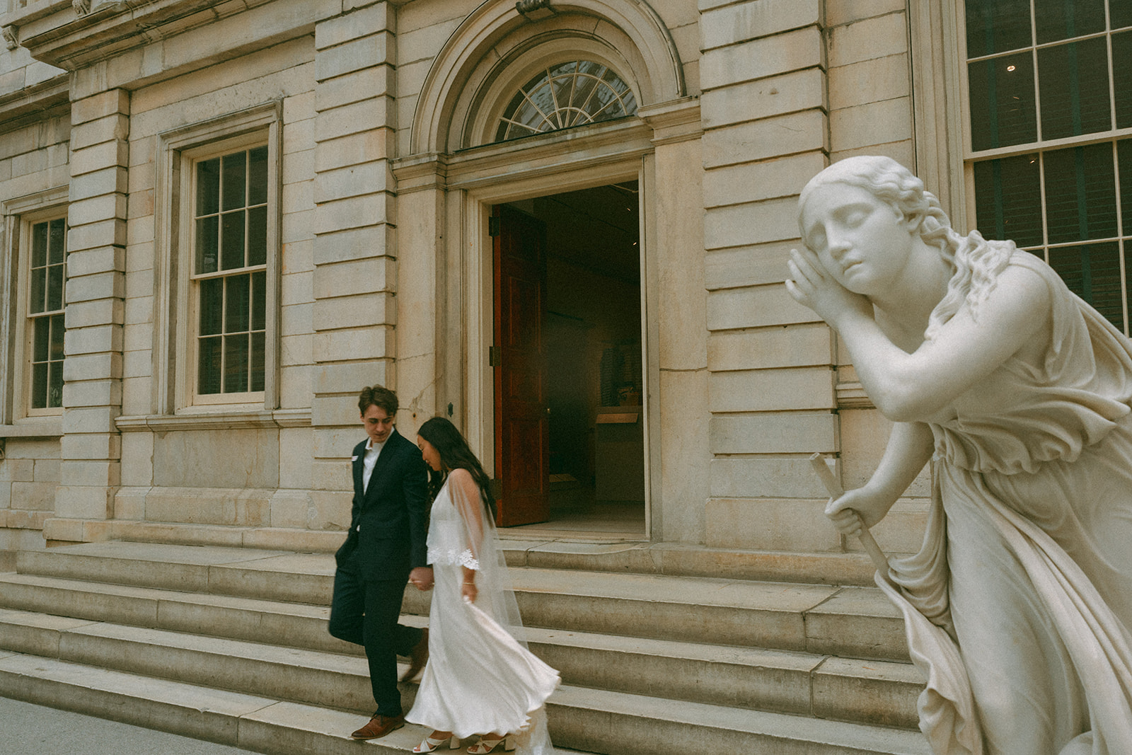 Alex + Bardo NYC Elopement Photos bride and groom walking down stairs at the Met for elopement photos, shot by elsie goodman, a destination, wedding and NYC elopement photographer