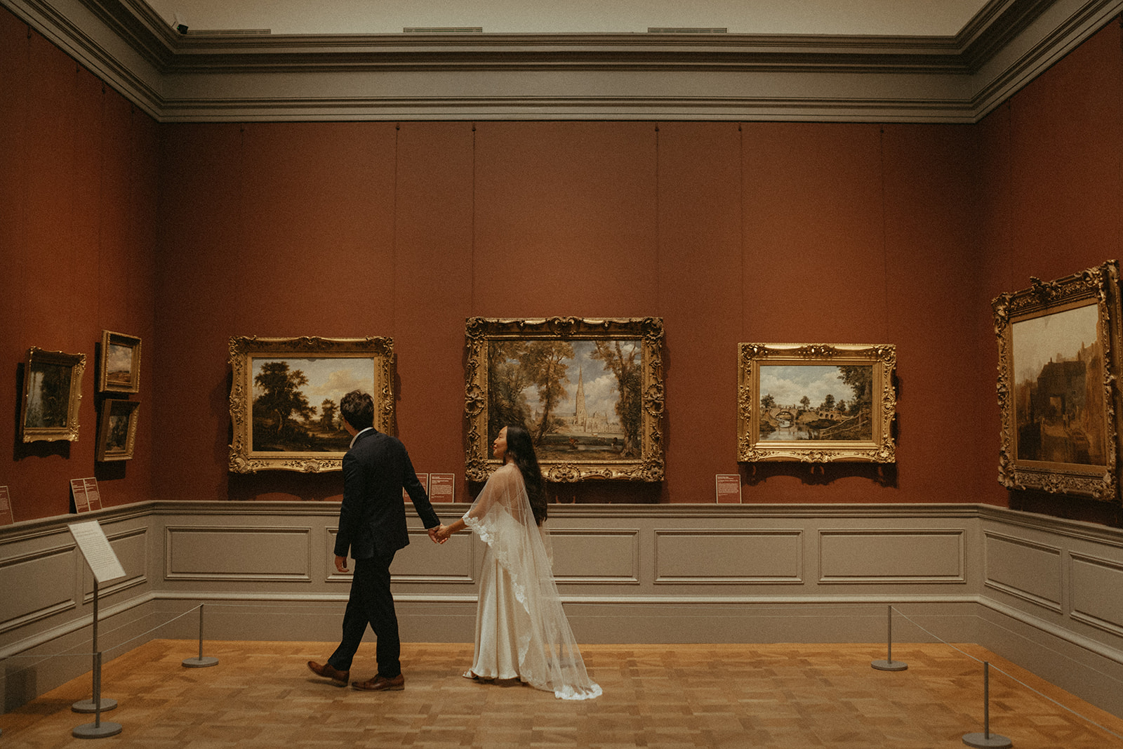 Alex + Bardo NYC Elopement Photos bride and groom walking in painting gallery at the Met for elopement photos, shot by elsie goodman, a destination, wedding and NYC elopement photographer