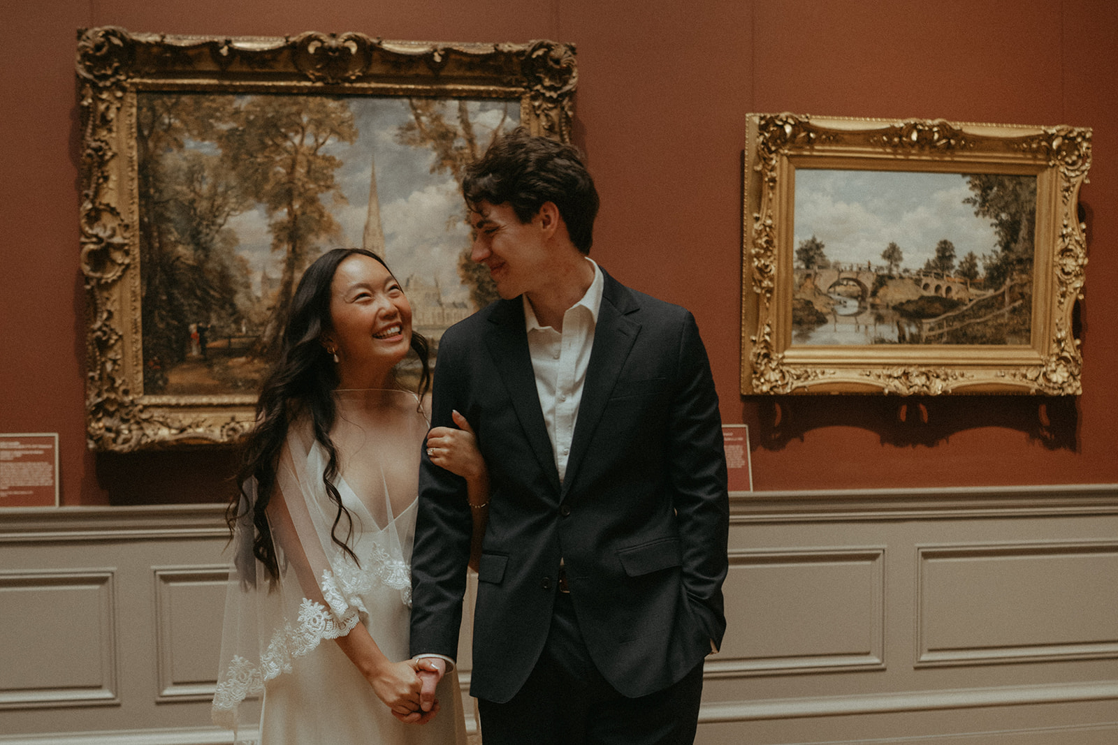 Alex + Bardo NYC Elopement Photos bride and groom smiling at each other in front of painting at the Met for elopement photos, shot by elsie goodman, a destination, wedding and NYC elopement photographer