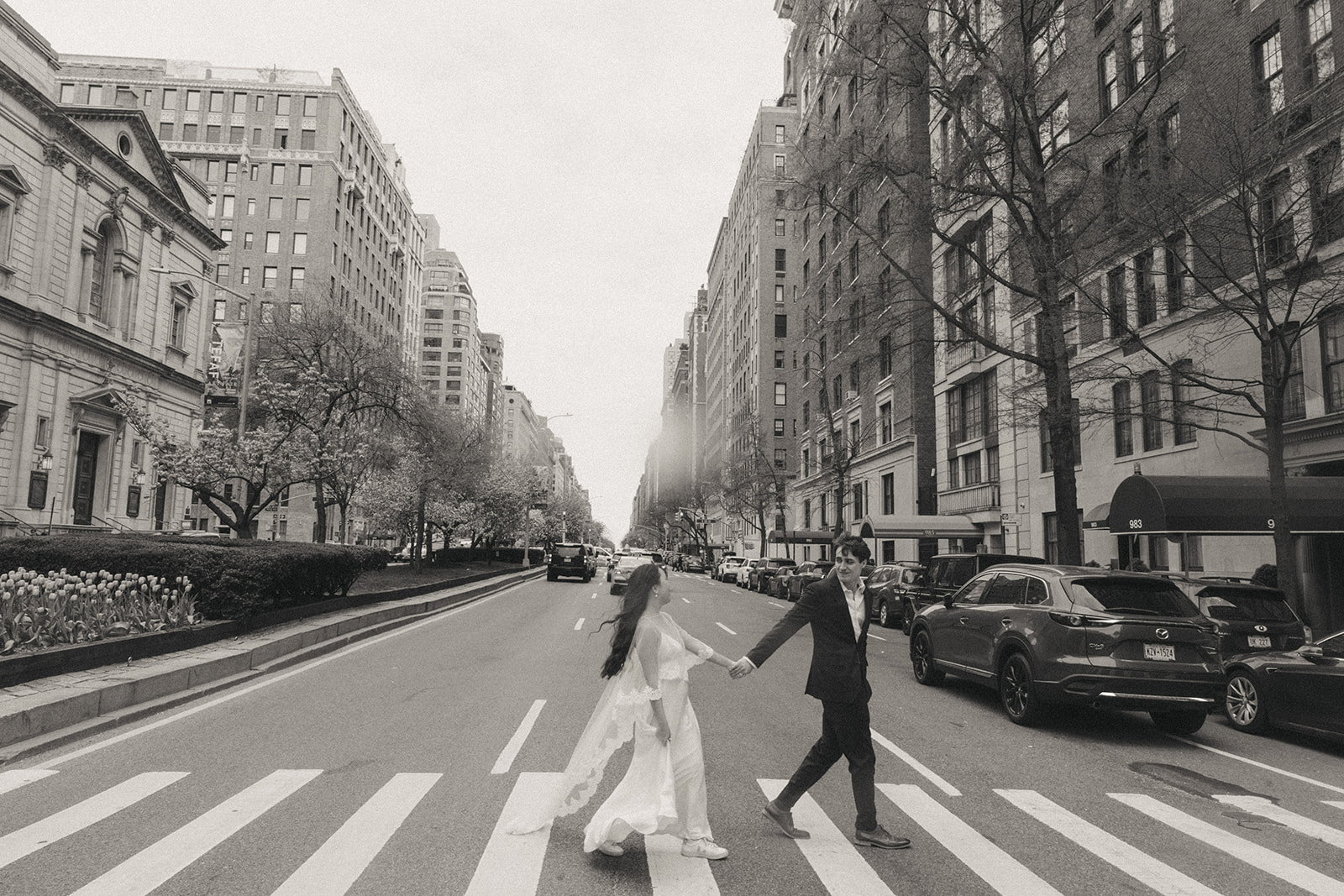 Alex + Bardo NYC Elopement Photos bride and groom crossing the street in NYC, shot by elsie goodman, a destination, wedding and NYC elopement photographer