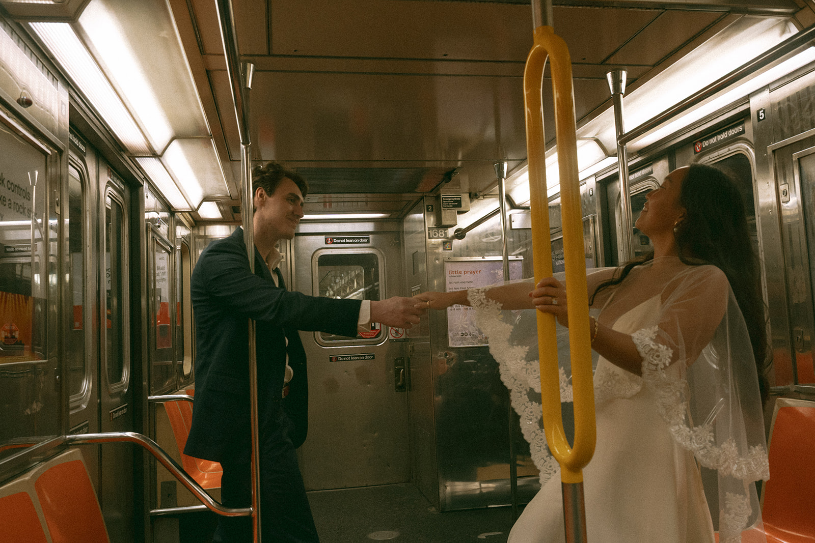 bride and groom dancing on nyc subway to city hall elopement, shot by elsie goodman, a destination, wedding and NYC elopement photographer