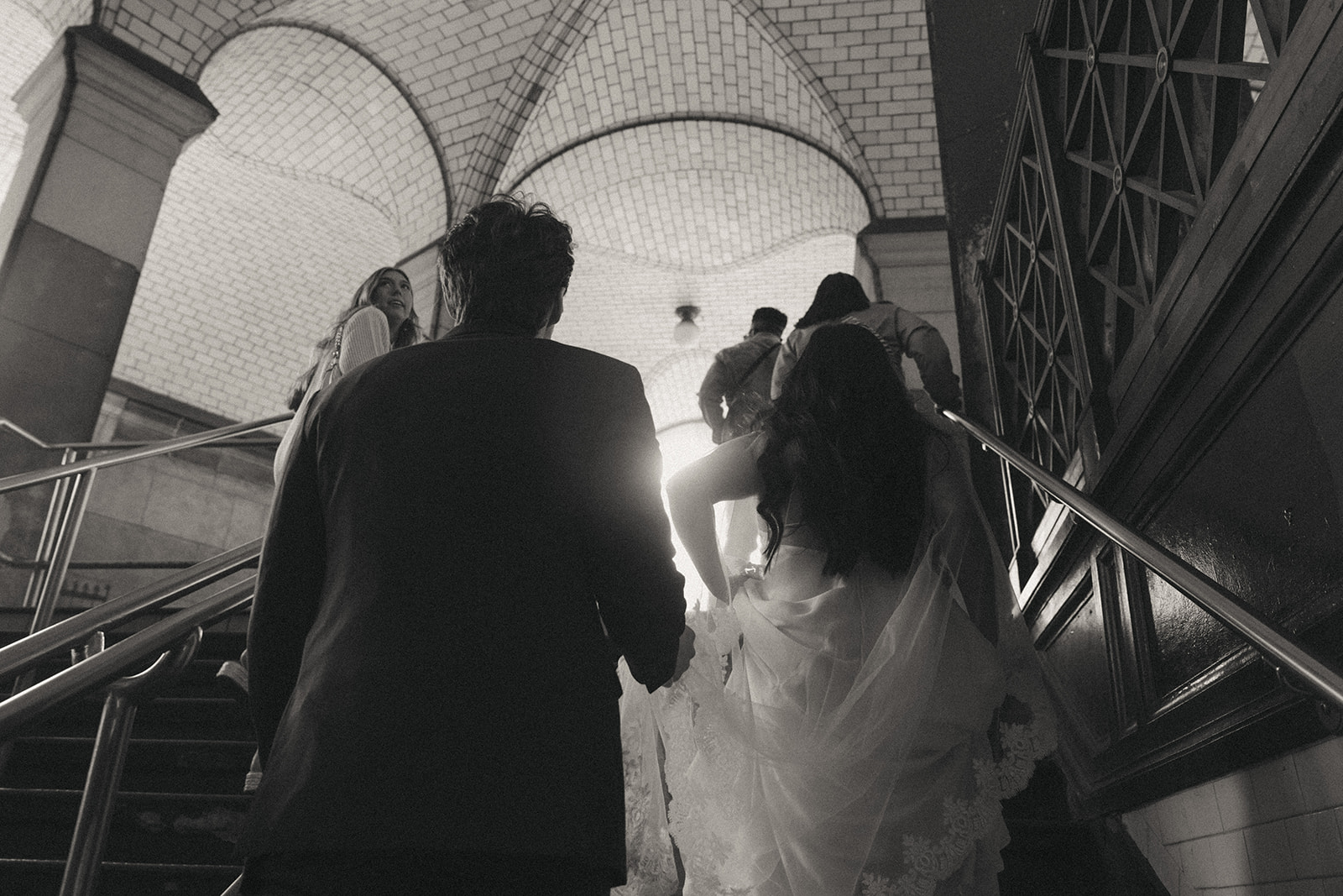 Alex + Bardo NYC Elopement Photos bride and groom exiting the nyc subway to their city hall elopement, shot by elsie goodman, a destination, wedding and NYC elopement photographer
