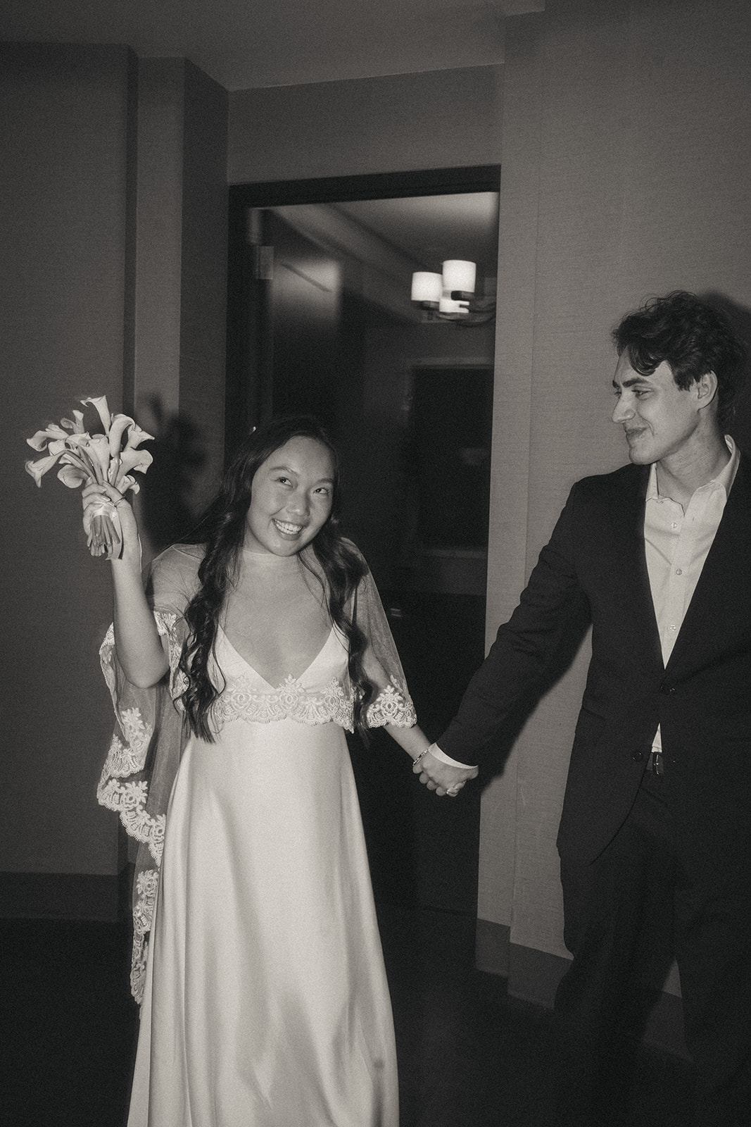Alex + Bardo NYC Elopement Photos bride and groom holding hands and smiling after eloping at city hall in nyc, shot by elsie goodman, a destination, wedding and NYC elopement photographer