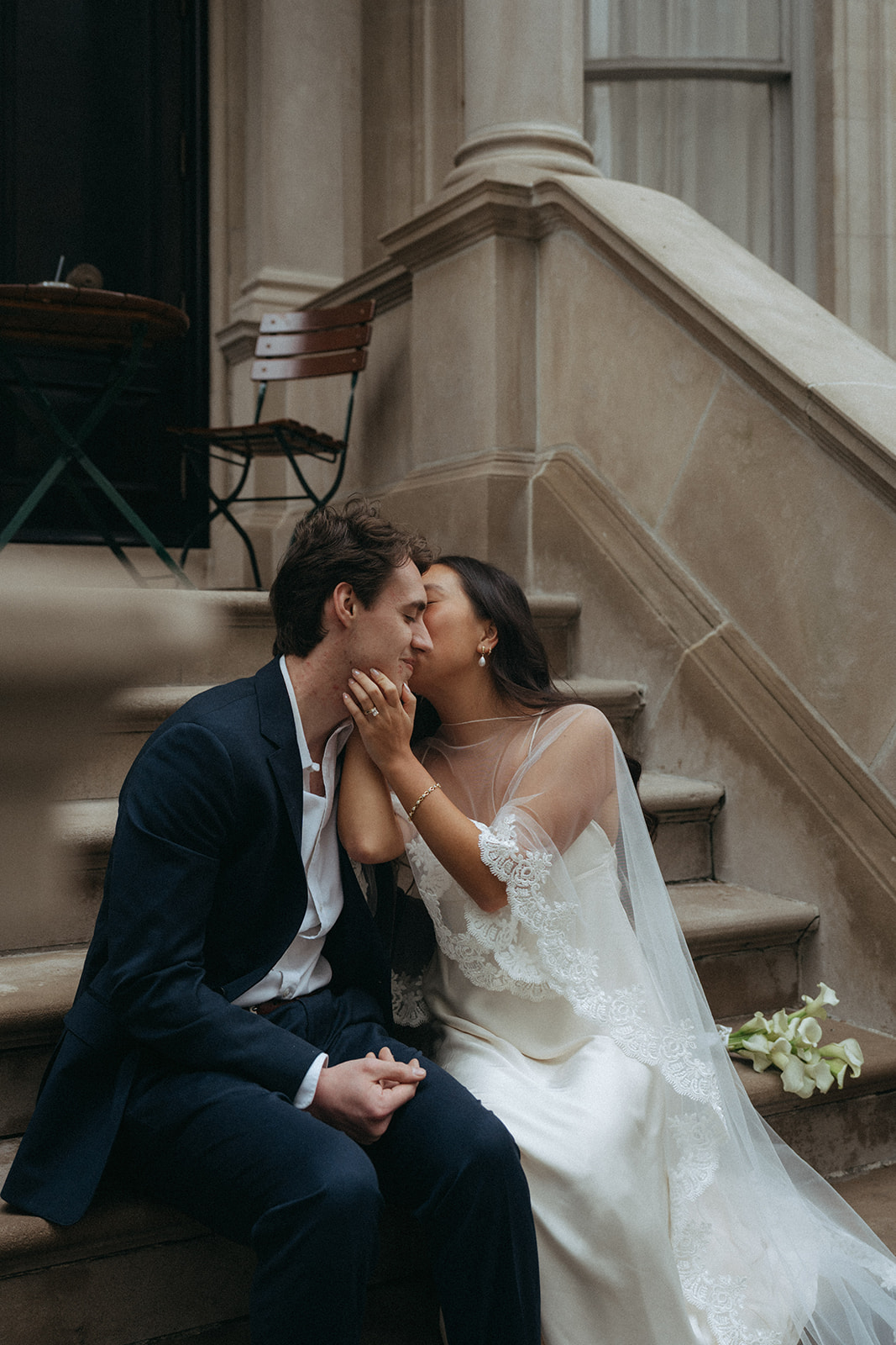 Alex + Bardo NYC Elopement Photos bride and groom kissing on stoop in NYC for elopement photos, shot by elsie goodman, a destination, wedding and NYC elopement photographer