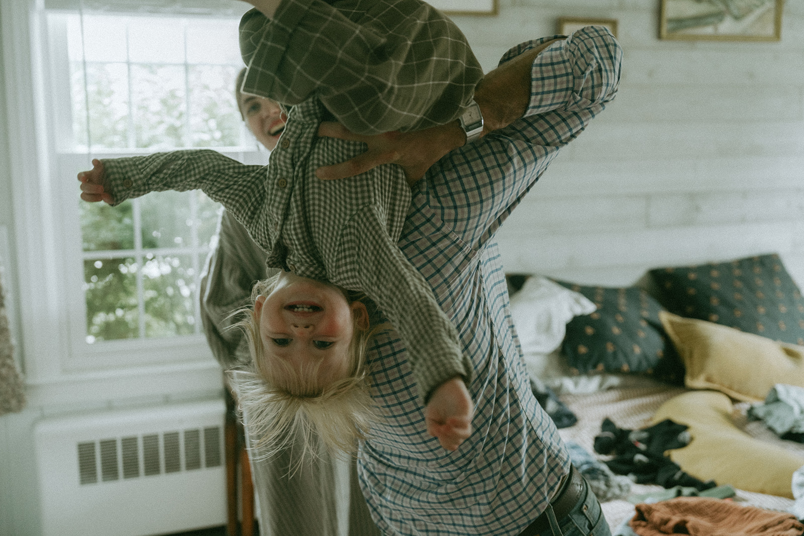 Dad plays with his child by maternity, family, and wedding photographer Elsie Goodman.