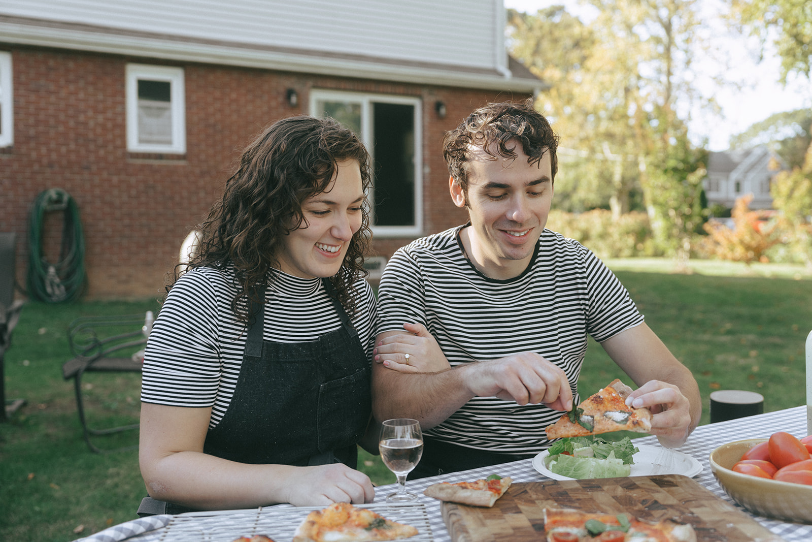 couple enjoying a pizza in their backyard by the wedding and couples photographer, Elsie Goodman.