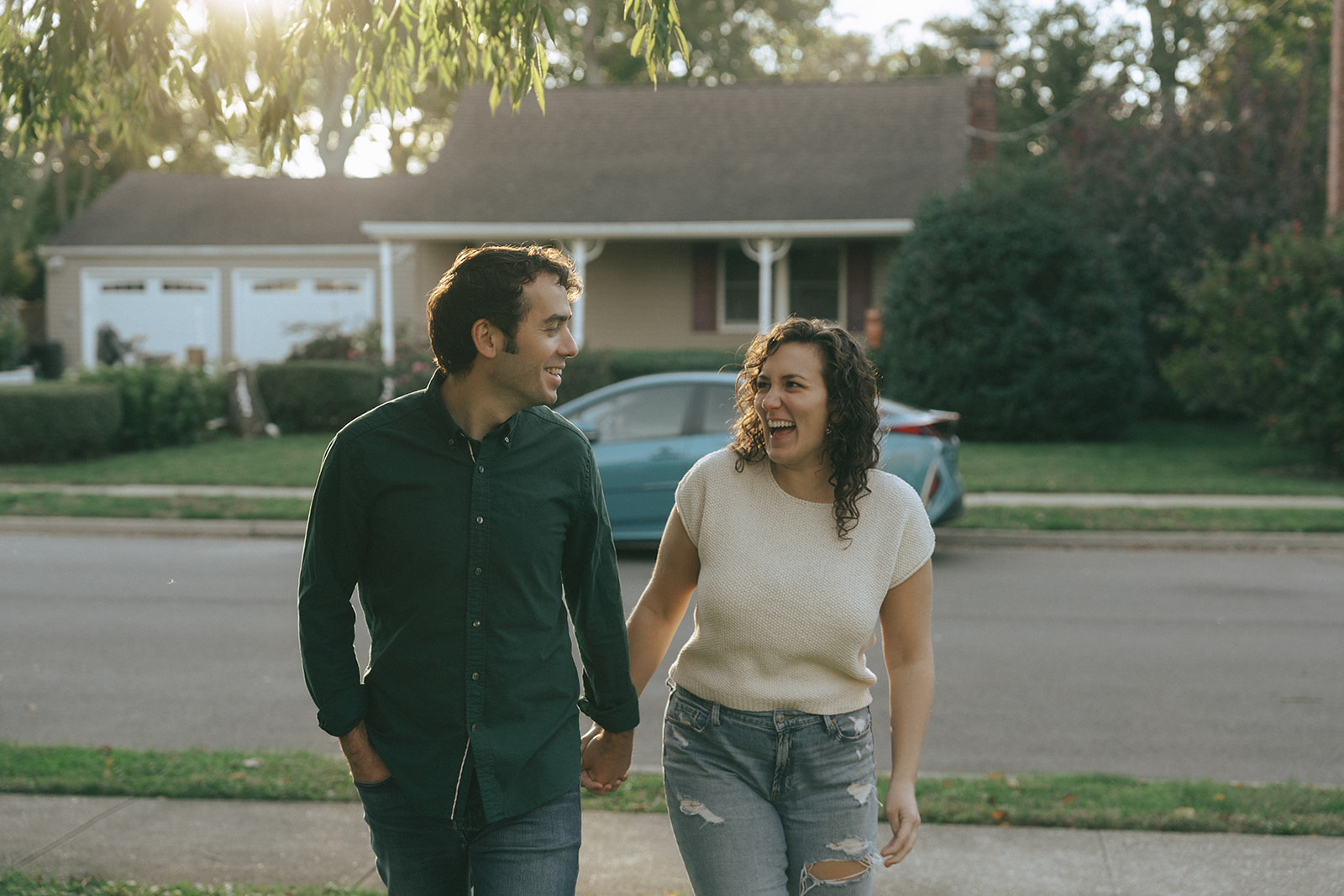 Couple holding hands, walking towards the camera, taken during sunset by wedding and couples photographer Elsie Goodman.