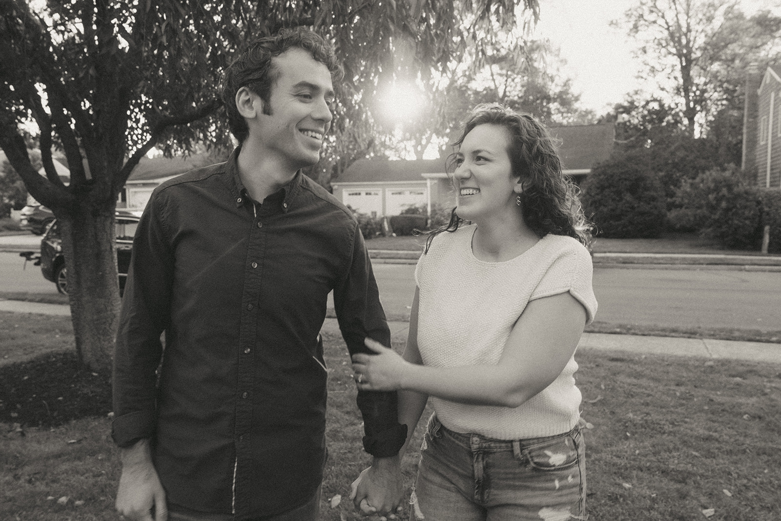 Black and white photo of a couple holding hands by wedding and couples photographer Elsie Goodman.