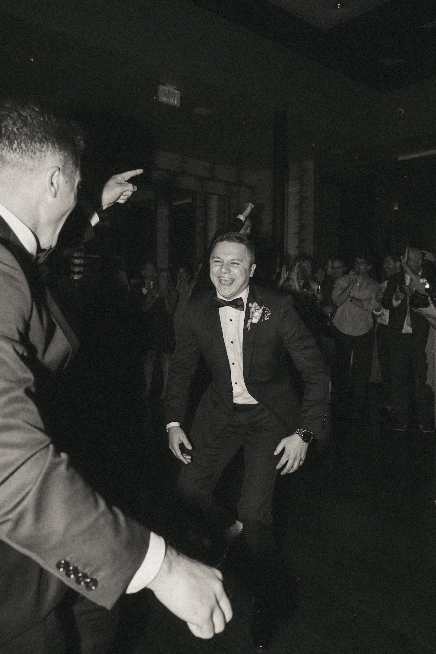 Guest dancing in a tuxedo, an unscripted wedding reception shot list moment