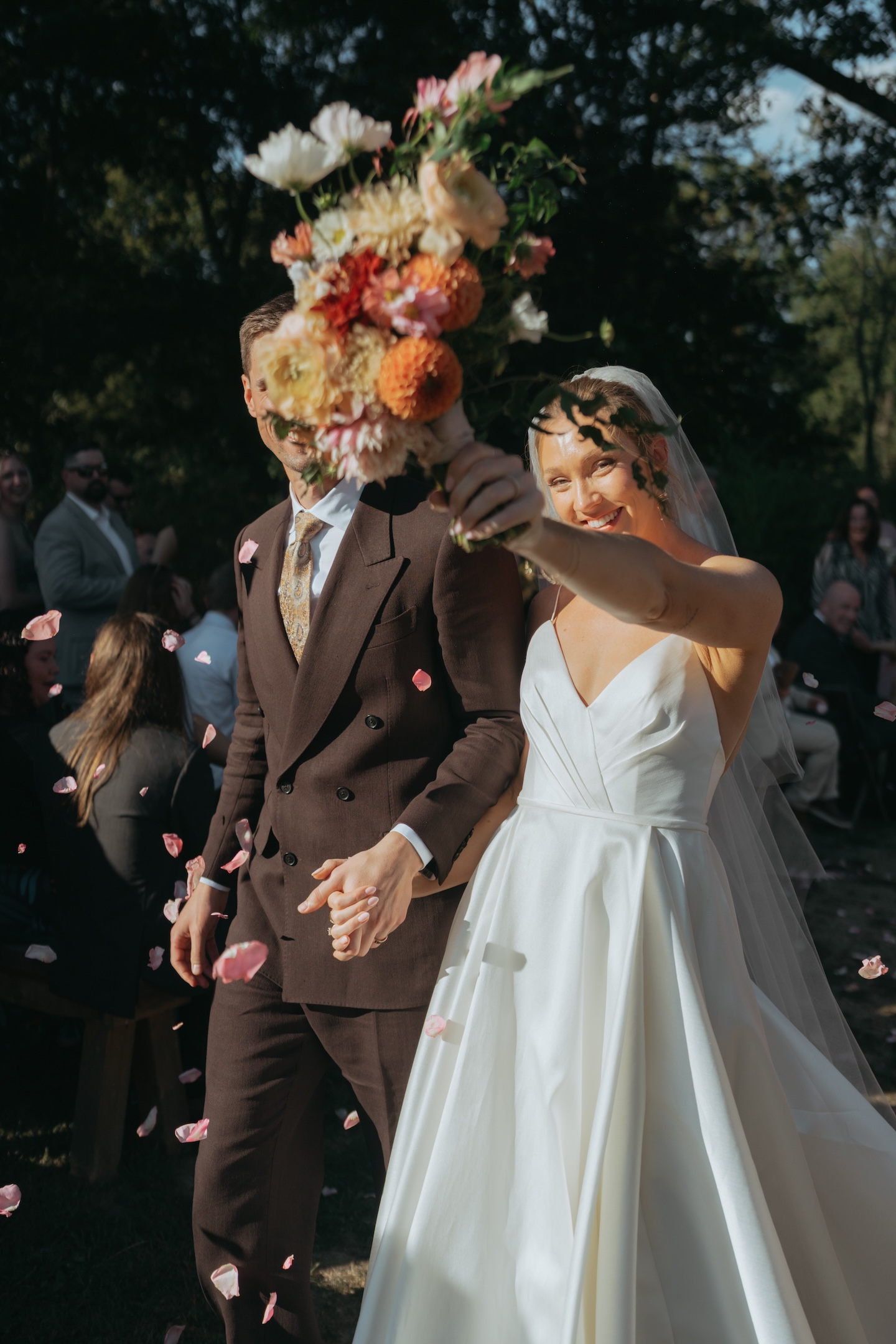 Bride in a floral headpiece with her groom in a brown suit for an autumn wedding shot list