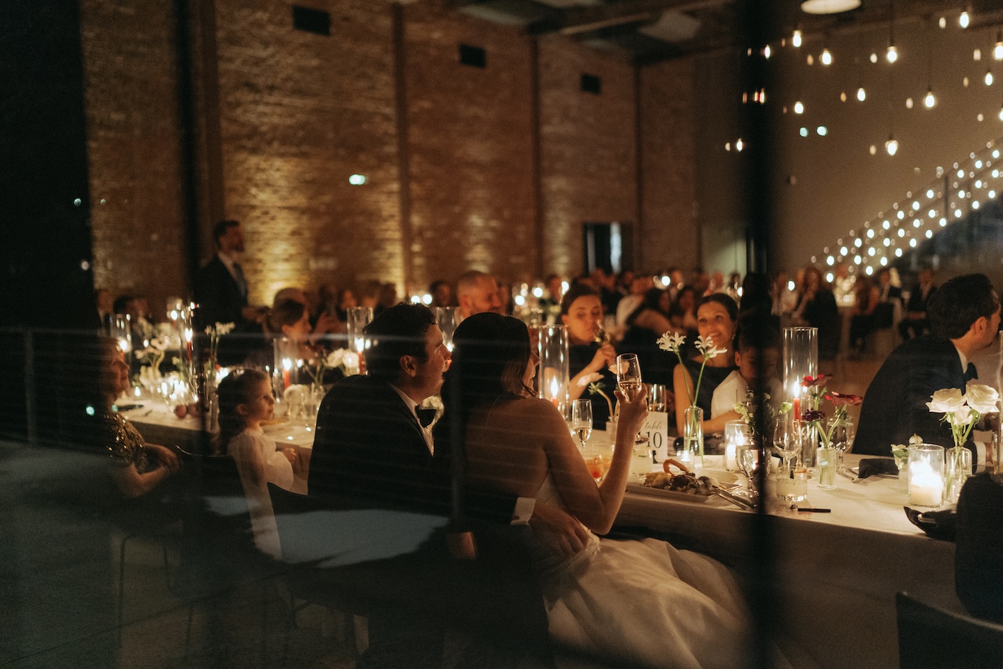 Reception under warm string lights, a venue detail for the wedding reception shot list